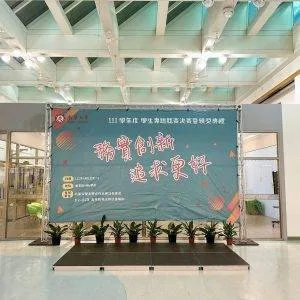 展架上面綁一面大圖，內容關於務實創新，追求更好等字樣活動內容-正面視角